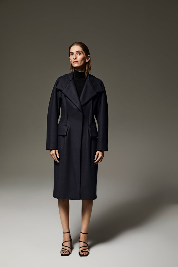 Dark Blue Amalia coat featuring kimono sleeves, a versatile collar, and flap pockets.